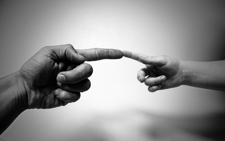 A person and a child figures touching each other