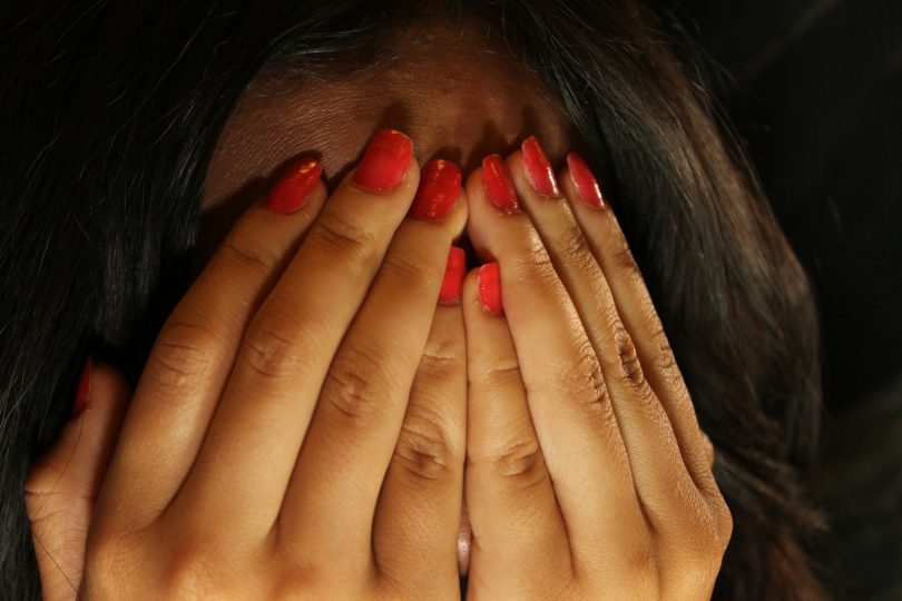 Woman showing toxic shame with hands